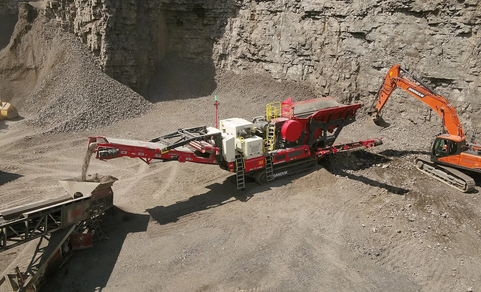 Sandvik UJ443E tracked mobile jaw crusher processing hard rock in a quarry